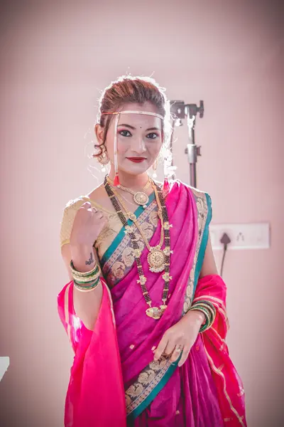 Maharashtrian wedding look with green bangles and traditional gold jewellery