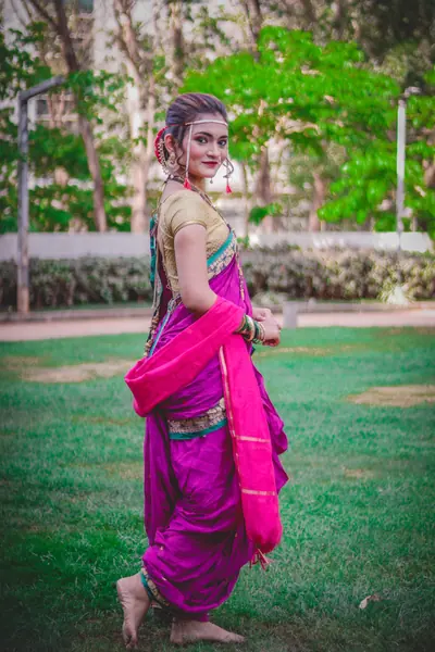 Maharashtrian bride in a nauvari saree with chandrakor bindi, nath and pearl mundavalya
